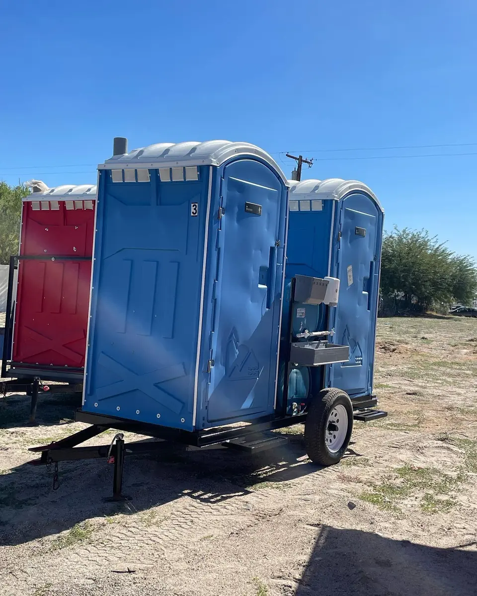 Porta potties mounted on a towable trailer for moving crews